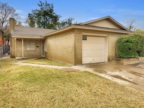 3209 66th Street, Unit A Lubbock, TX 79413 - Photo 1 of 10 a front view of a house with a yard
