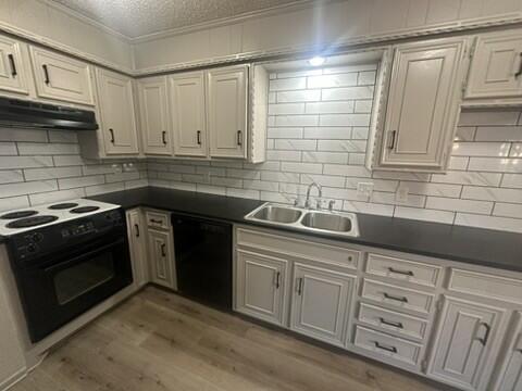 3209 66th Street, Unit A Lubbock, TX 79413 - Photo 4 of 10 a kitchen with granite countertop a sink stainless steel appliances and cabinets