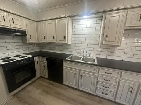 a kitchen with granite countertop cabinets stainless steel appliances and sink