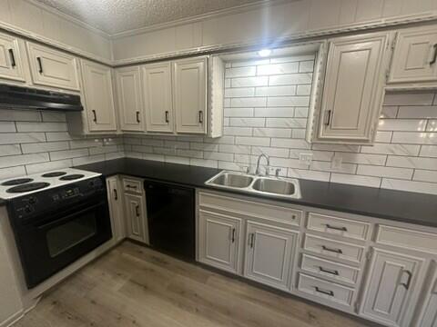 3209 66th Street, Unit A Lubbock, TX 79413 - Photo 5 of 10 a kitchen with granite countertop cabinets stainless steel appliances and sink