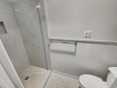 3209 66th Street, Unit A Lubbock, TX 79413 - Photo 7 of 10 a bathroom with a shower and toilet