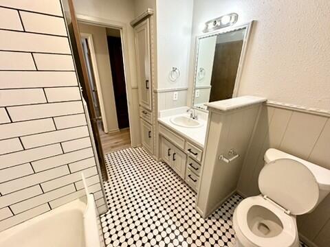 3209 66th Street, Unit A Lubbock, TX 79413 - Photo 9 of 10 a bathroom with a sink a toilet a mirror and shower