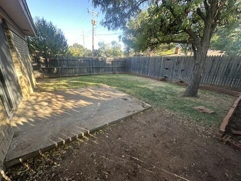 3209 66th Street, Unit A Lubbock, TX 79413 - Photo 10 of 10 a view of a yard with large trees and wooden fence