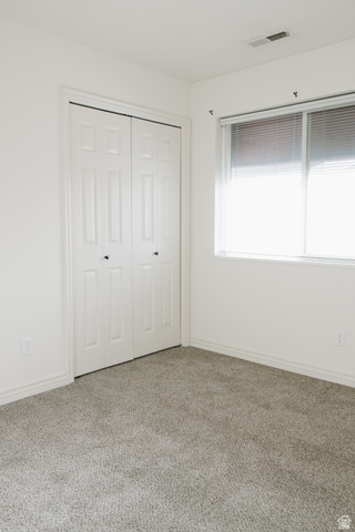 215 South 1050th West, Unit 10 Provo, UT 84601 - Photo 15 of 38 Unfurnished bedroom with carpet floors and a closet