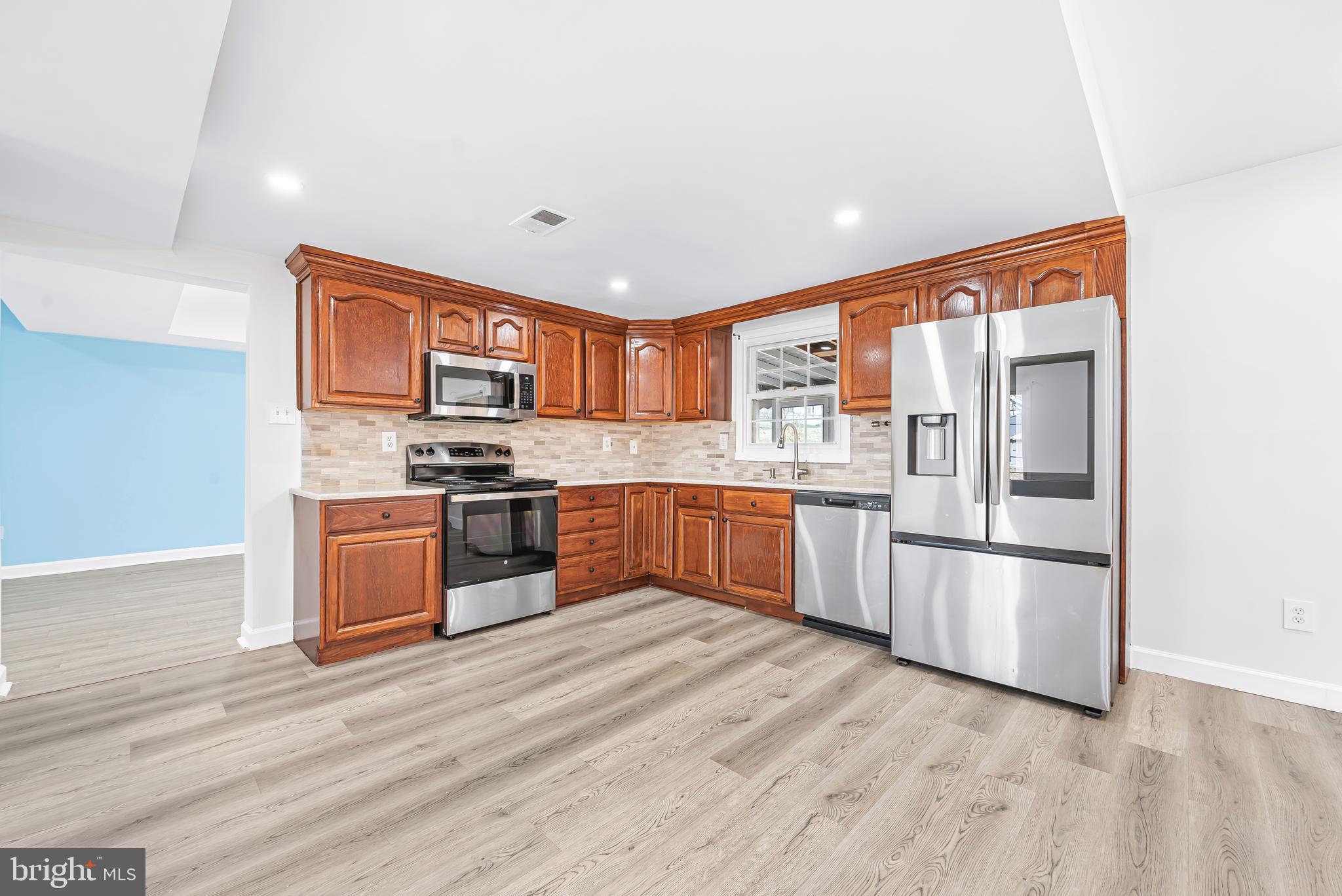 7958 Citadel Drive Severn, MD 21144 - Photo 12 of 32 a kitchen with stainless steel appliances granite countertop a refrigerator and a stove top oven