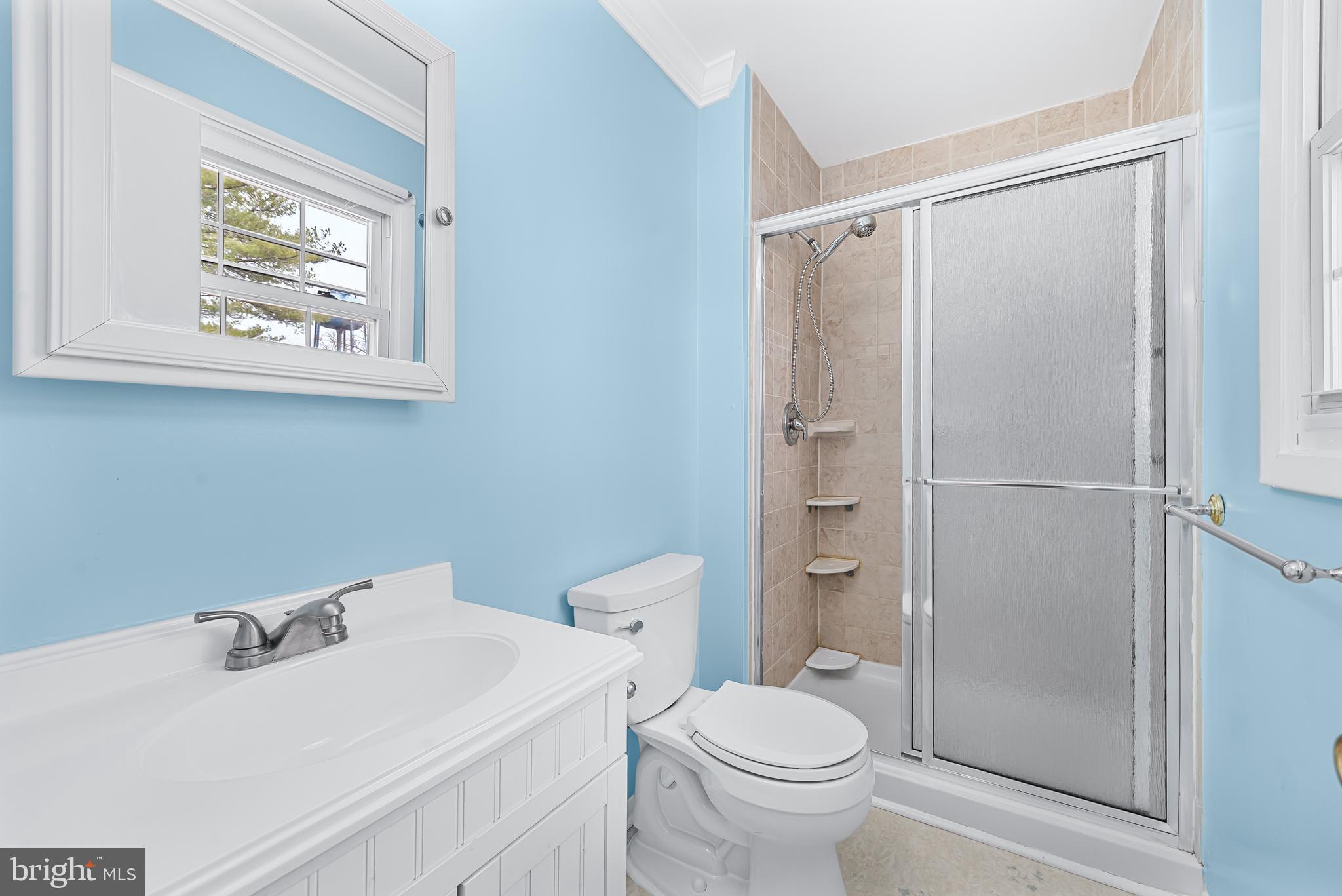 7958 Citadel Drive Severn, MD 21144 - Photo 28 of 32 a bathroom with a sink toilet and shower