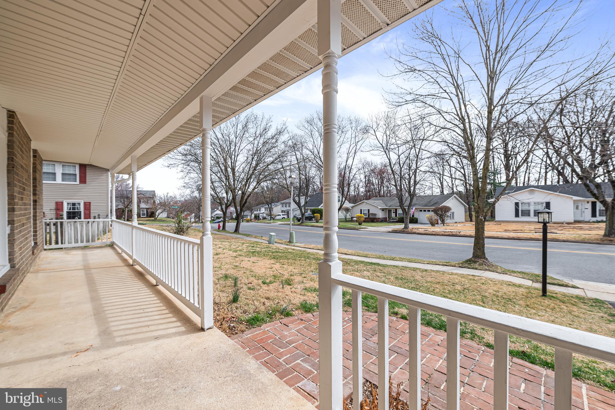 7958 Citadel Drive Severn, MD 21144 - Photo 4 of 32 a view of a street with a yard and trees