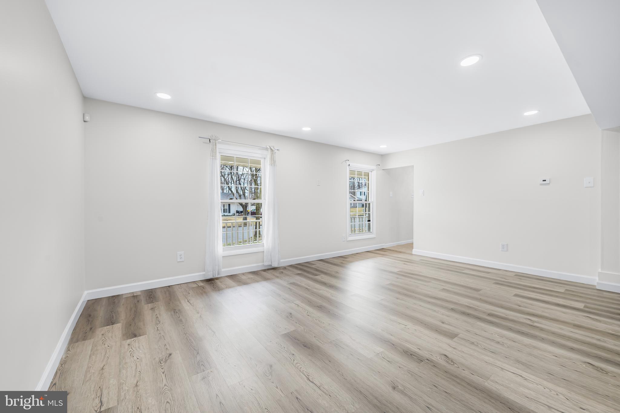 7958 Citadel Drive Severn, MD 21144 - Photo 9 of 32 a view of an empty room with wooden floor and window