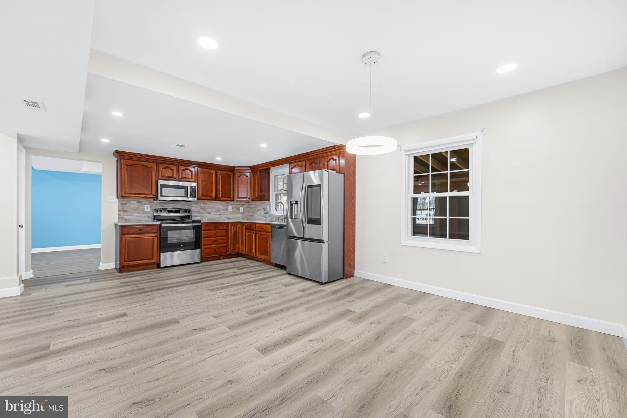 7958 Citadel Drive Severn, MD 21144 - Photo 10 of 32 a large kitchen with stainless steel appliances granite countertop a stove and a sink