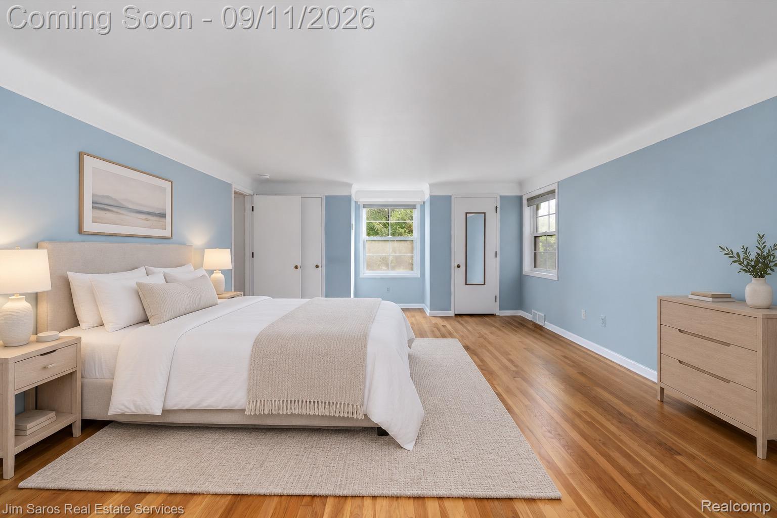 1445 Devonshire Road Grosse Pointe, MI 48230 - Photo 16 of 30 Light blue walls with white crown molding, wood-finish flooring, and multiple windows