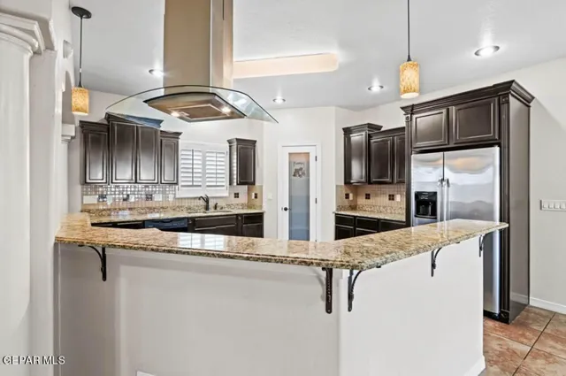 a kitchen with stainless steel appliances granite countertop a sink and refrigerator