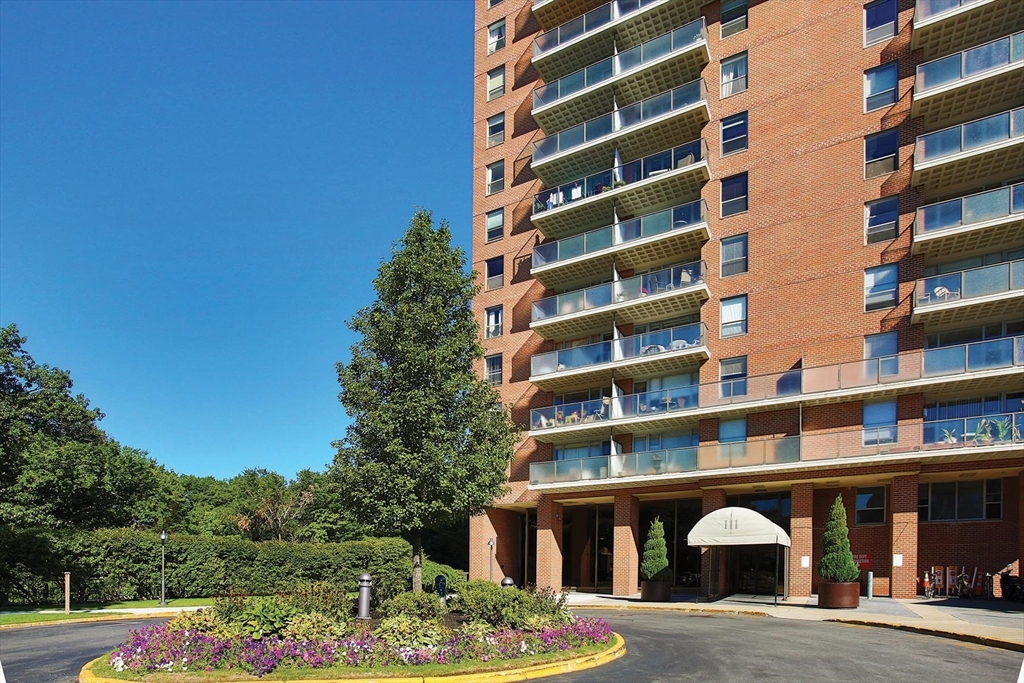 a front view of a building with a garden