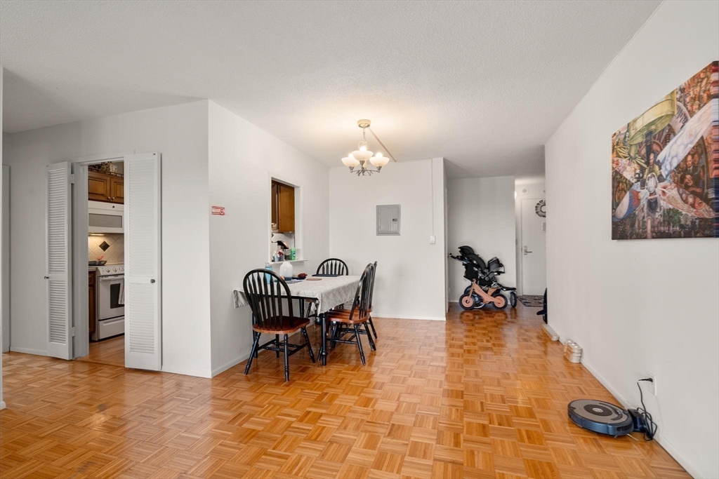 111 Perkins Street, Unit 83 Boston, MA 02130 - Photo 8 of 20 a view of a dining room with furniture and chandelier