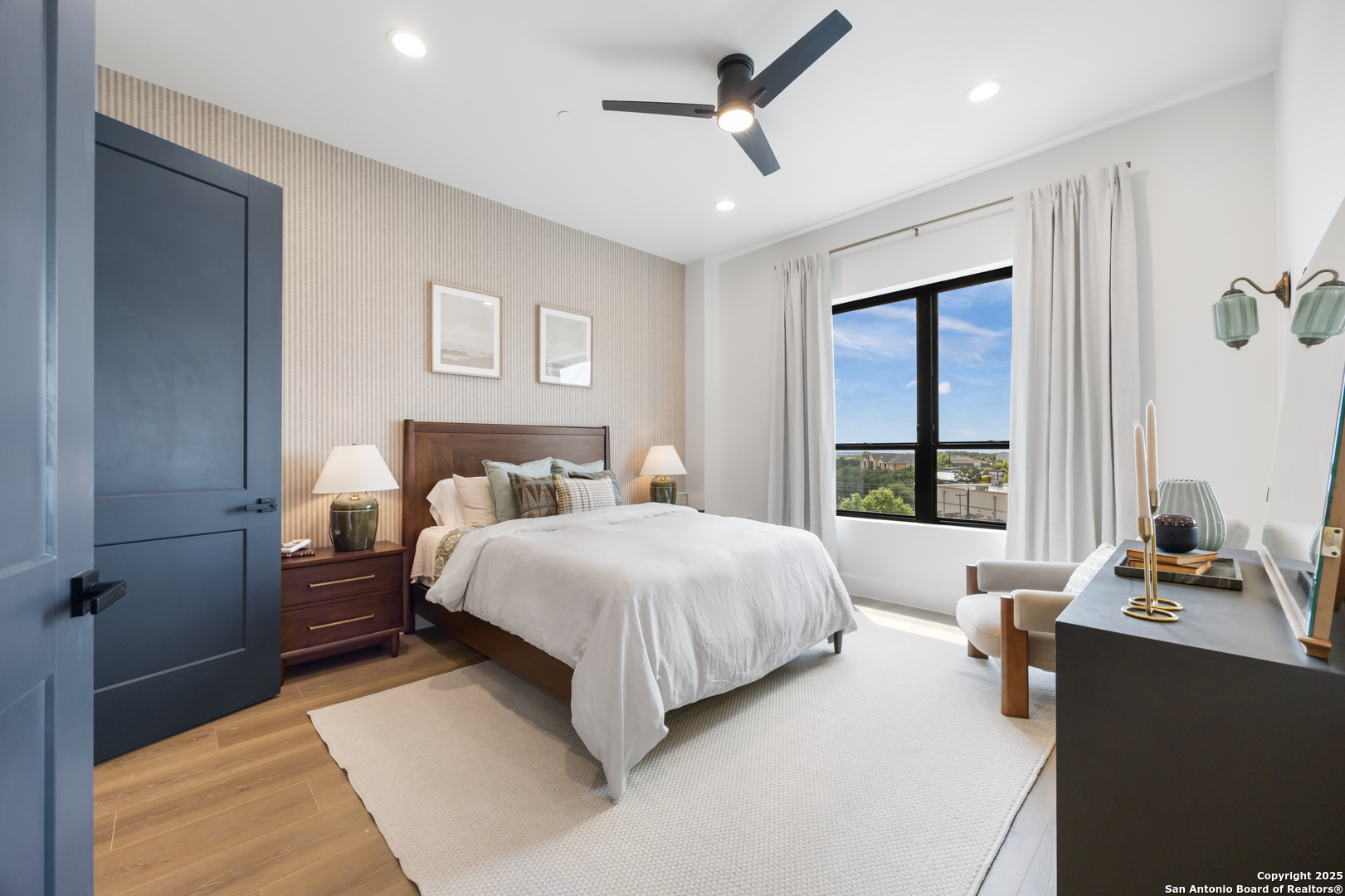 10899 South Hausman Road, Unit 204 San Antonio, TX 78249 - Photo 8 of 15 a bedroom with a bed and wooden floor