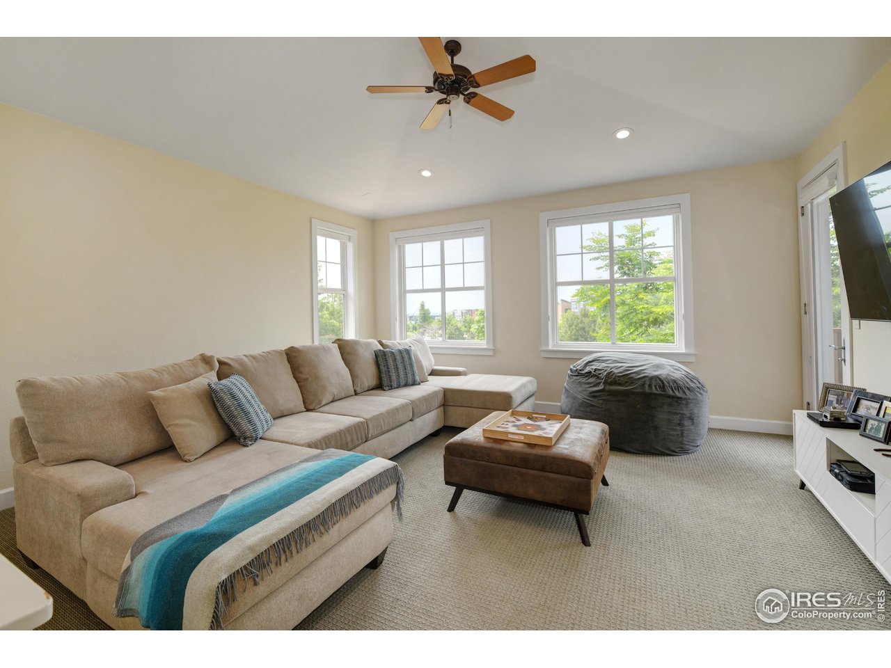 755 Terrace Circle South Boulder, CO 80304 - Photo 18 of 38 a living room with furniture and a flat screen tv