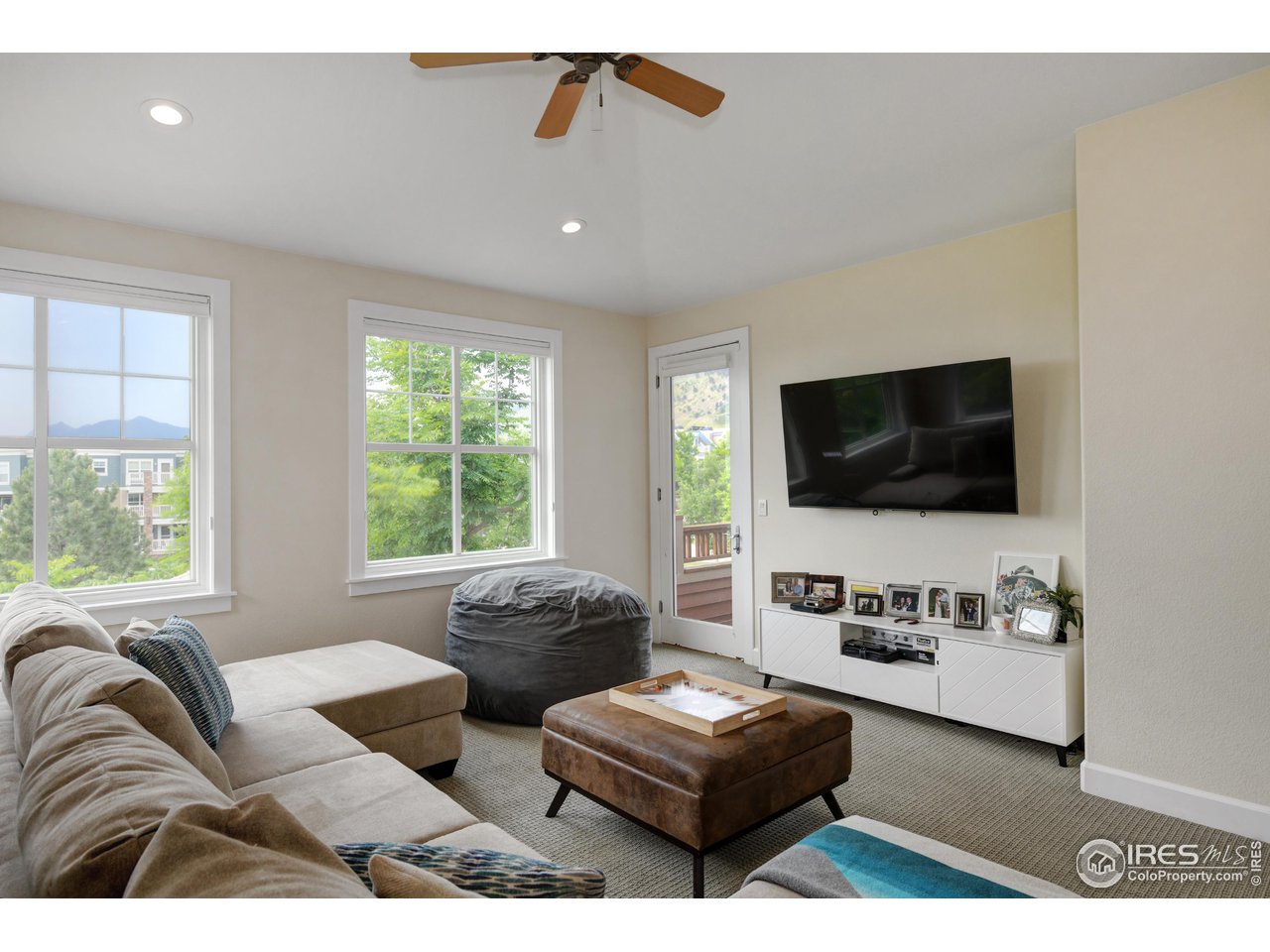 755 Terrace Circle South Boulder, CO 80304 - Photo 19 of 38 a living room with furniture and a flat screen tv