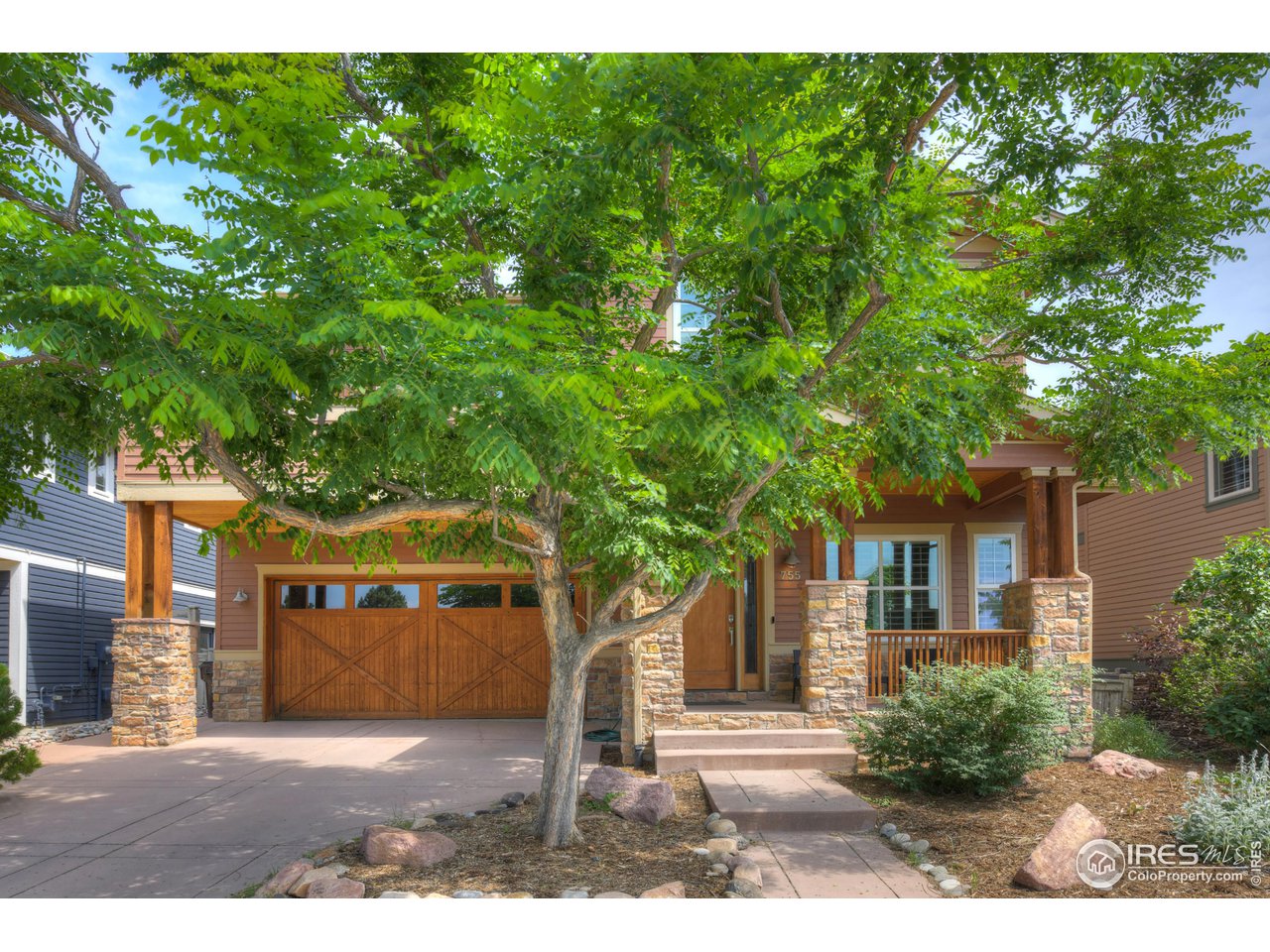 755 Terrace Circle South Boulder, CO 80304 - Photo 2 of 38 a front view of a house with a garden and tree