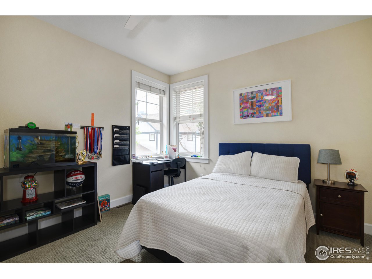 755 Terrace Circle South Boulder, CO 80304 - Photo 27 of 38 a bed room with a bed a television and a window