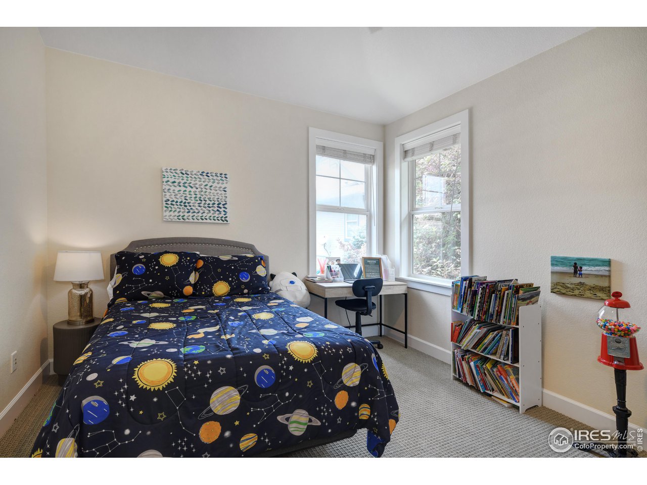 755 Terrace Circle South Boulder, CO 80304 - Photo 29 of 38 a bedroom with a bed a table and a bookshelf