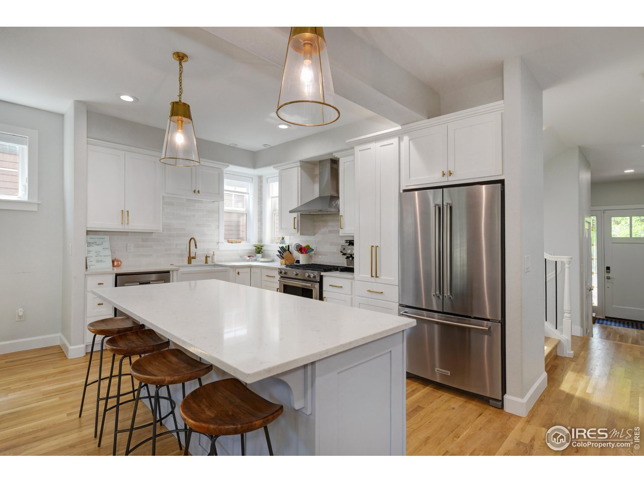 755 Terrace Circle South Boulder, CO 80304 - Photo 8 of 38 a kitchen with stainless steel appliances a stove a refrigerator a sink a dining table and chairs