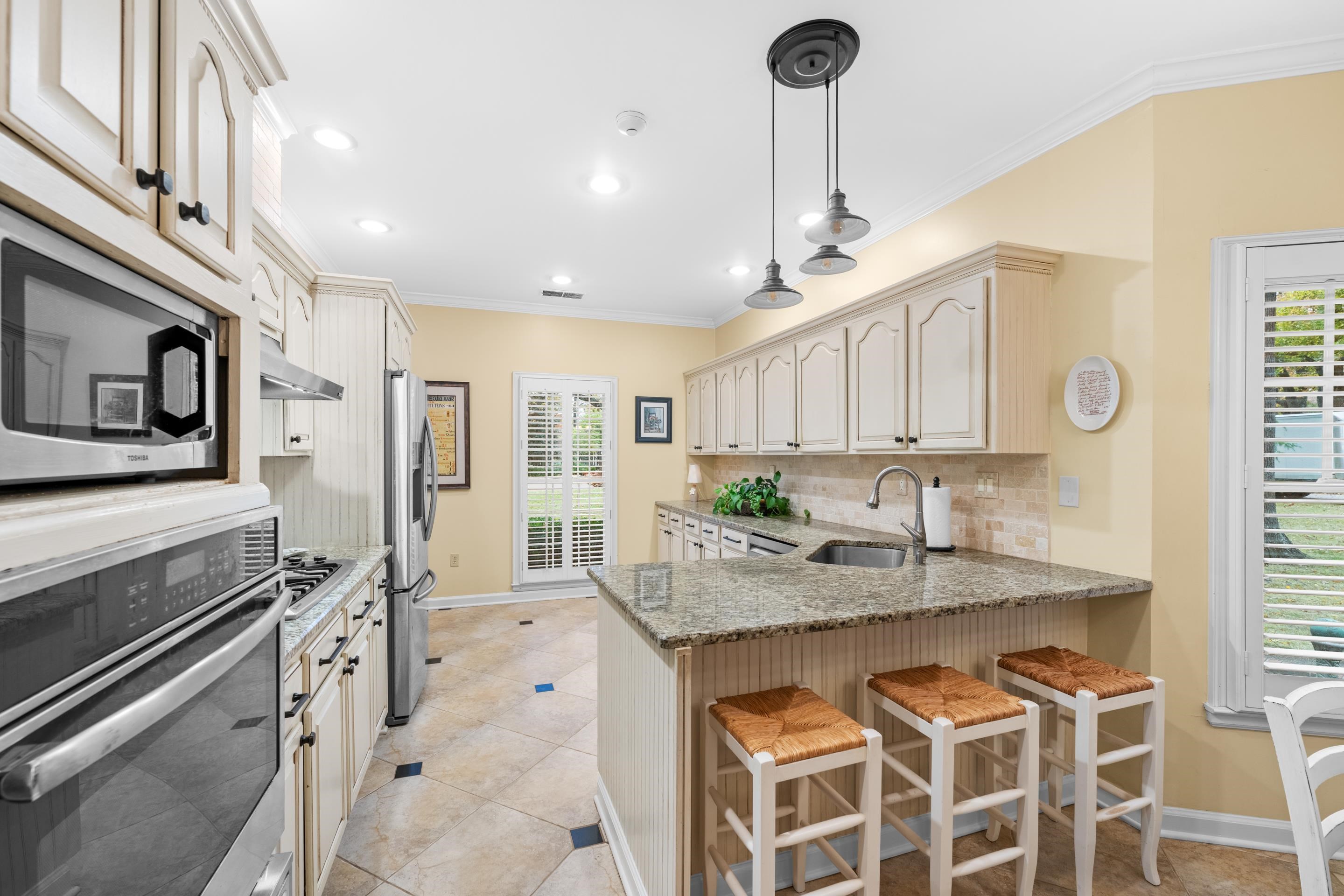 3430 Shea Road Collierville, TN 38017 - Photo 11 of 40 a kitchen with stainless steel appliances granite countertop a sink a stove and a refrigerator