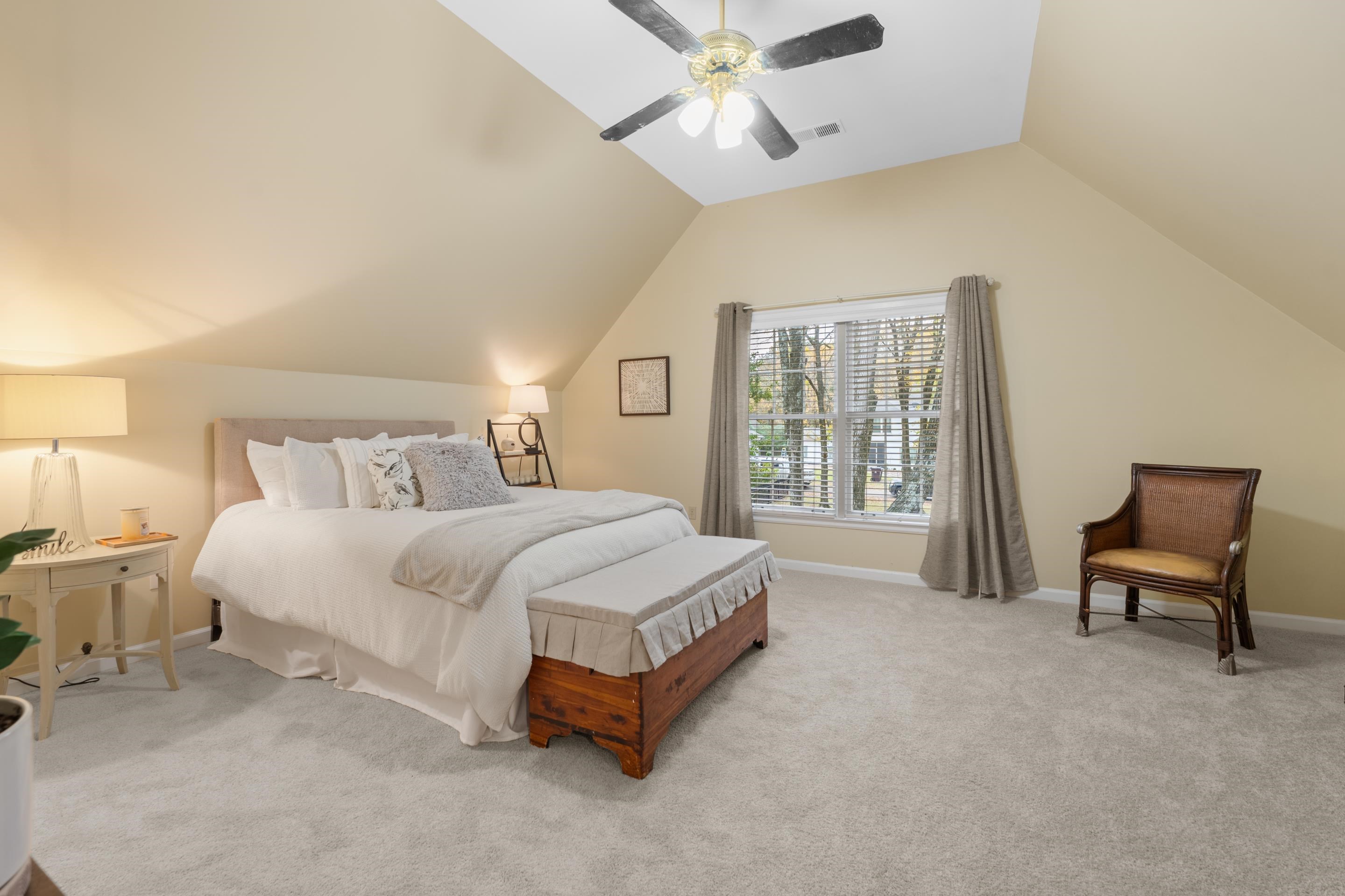 3430 Shea Road Collierville, TN 38017 - Photo 26 of 40 a spacious bedroom with a large bed and a chandelier