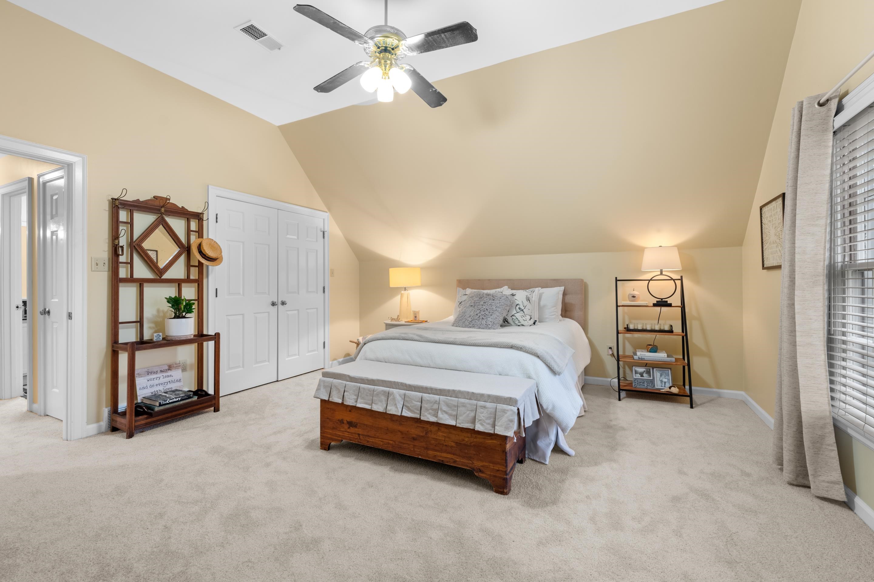 3430 Shea Road Collierville, TN 38017 - Photo 27 of 40 a spacious bedroom with a bed and a chandelier