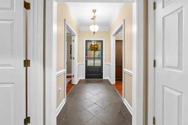 a view of a hallway with wooden shelves
