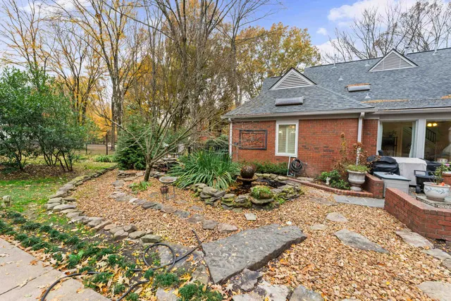 a swimming pool with outdoor seating and yard