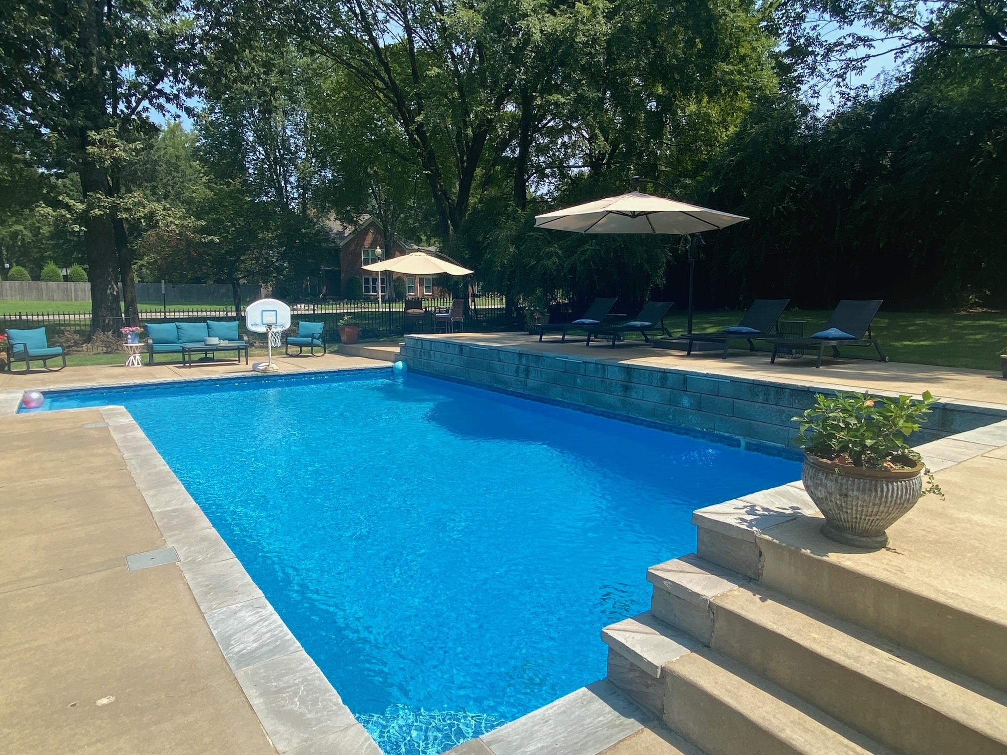 3430 Shea Road Collierville, TN 38017 - Photo 38 of 40 a view of a swimming pool with a table and chairs under an umbrella