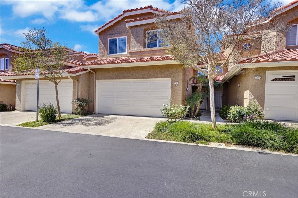28102 Bobwhite Circle, Unit 3 Saugus, CA 91350 - Photo 2 of 50 a front view of a house with a yard and garage