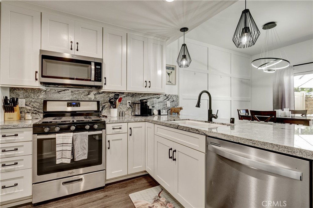 28102 Bobwhite Circle, Unit 3 Saugus, CA 91350 - Photo 21 of 50 a kitchen with stainless steel appliances a stove a sink and a microwave