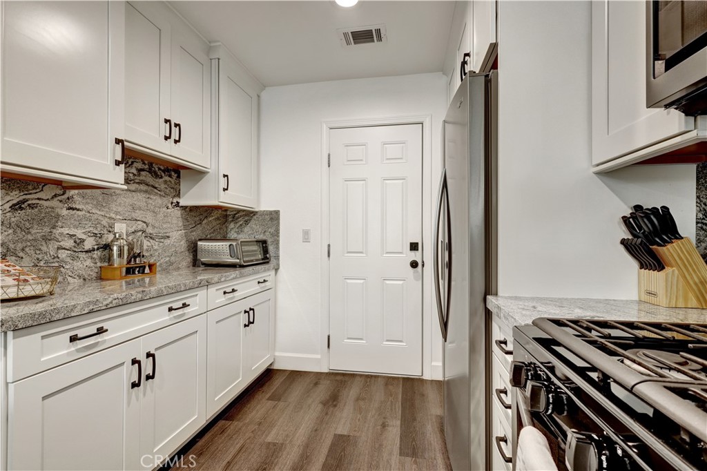 28102 Bobwhite Circle, Unit 3 Saugus, CA 91350 - Photo 22 of 50 a kitchen with white cabinets and appliances