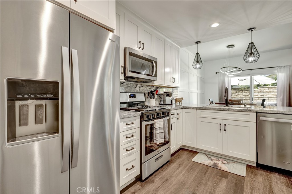28102 Bobwhite Circle, Unit 3 Saugus, CA 91350 - Photo 24 of 50 a kitchen with stainless steel appliances a refrigerator sink and microwave
