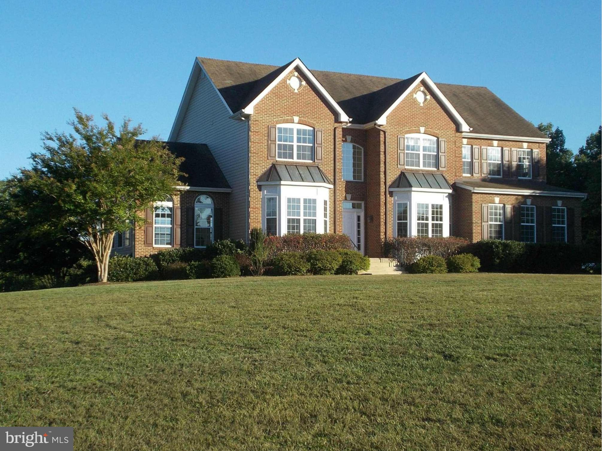7475 Flint Hill Road Owings, MD 20736 - Photo 1 of 30 a front view of a house with a yard