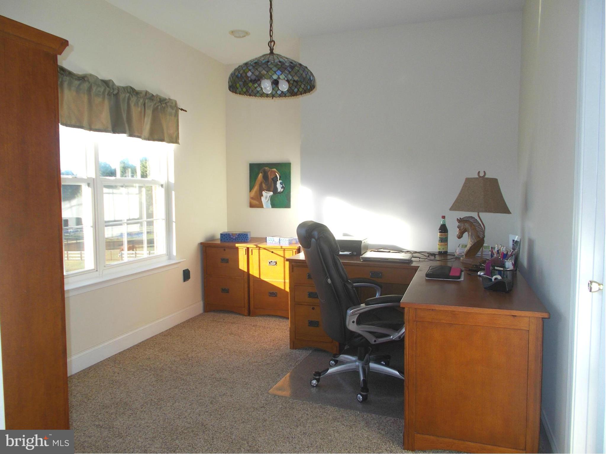 7475 Flint Hill Road Owings, MD 20736 - Photo 14 of 30 a view of a workspace with furniture and a window
