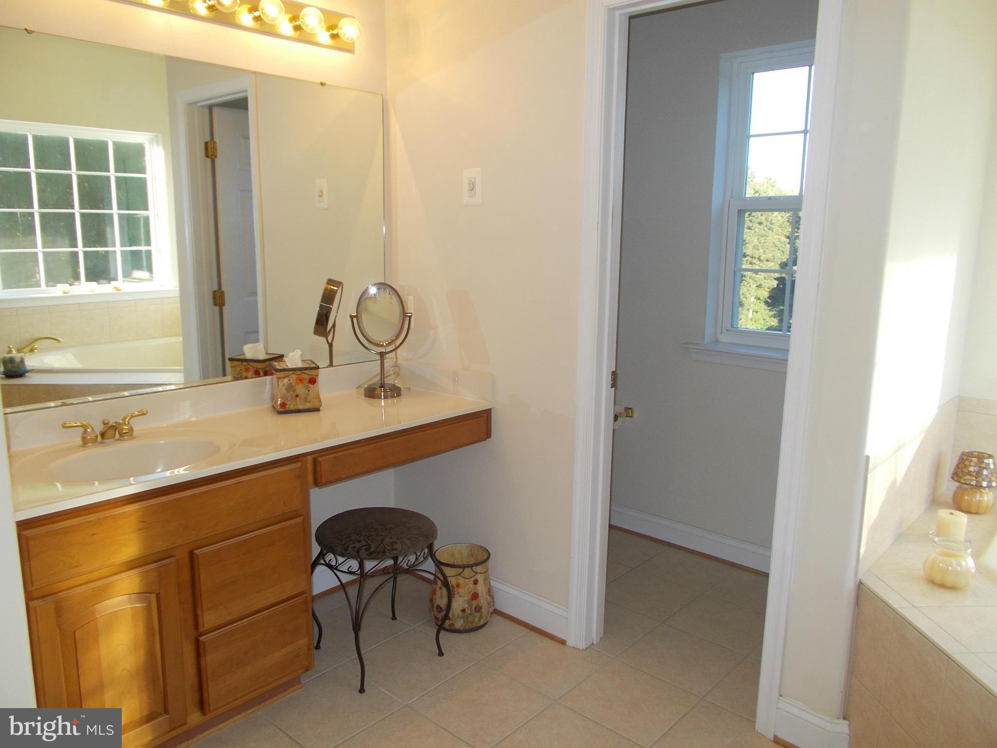 7475 Flint Hill Road Owings, MD 20736 - Photo 15 of 30 a bathroom with a sink and a mirror