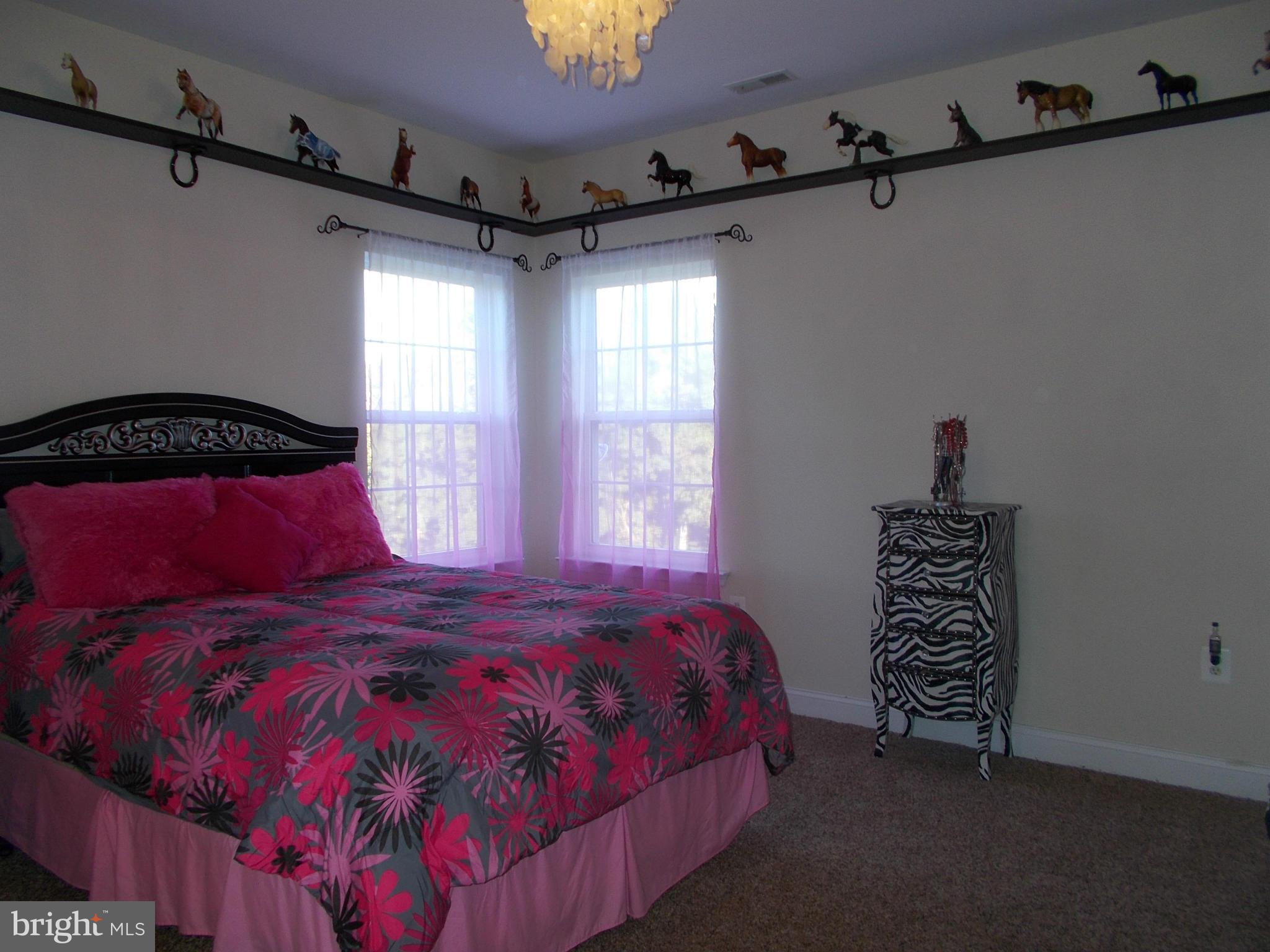 7475 Flint Hill Road Owings, MD 20736 - Photo 17 of 30 a bedroom with a bed and a window