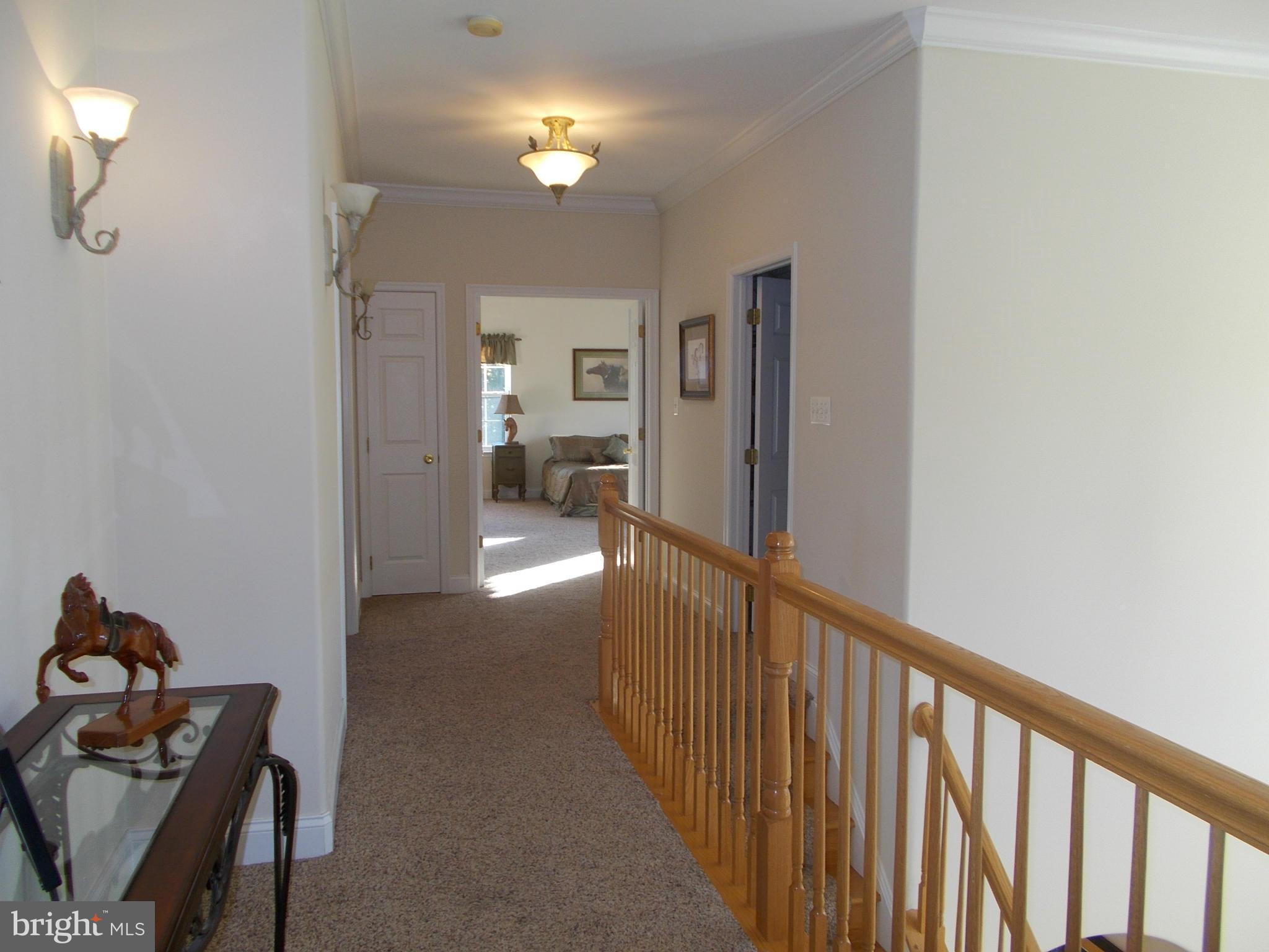 7475 Flint Hill Road Owings, MD 20736 - Photo 19 of 30 a view of a hallway with workspace and a livingroom with furniture