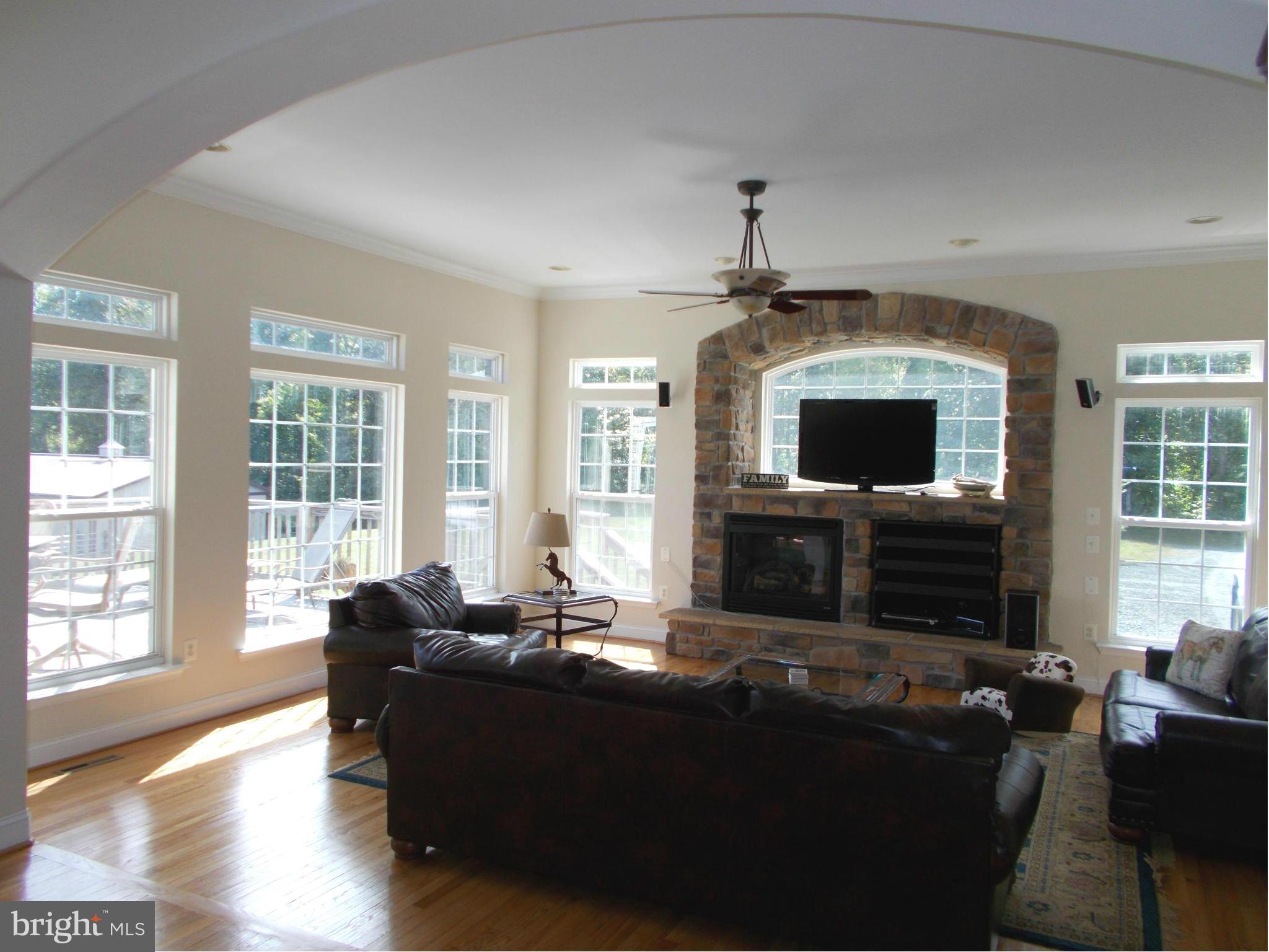 7475 Flint Hill Road Owings, MD 20736 - Photo 4 of 30 a living room with furniture a fireplace and a flat screen tv