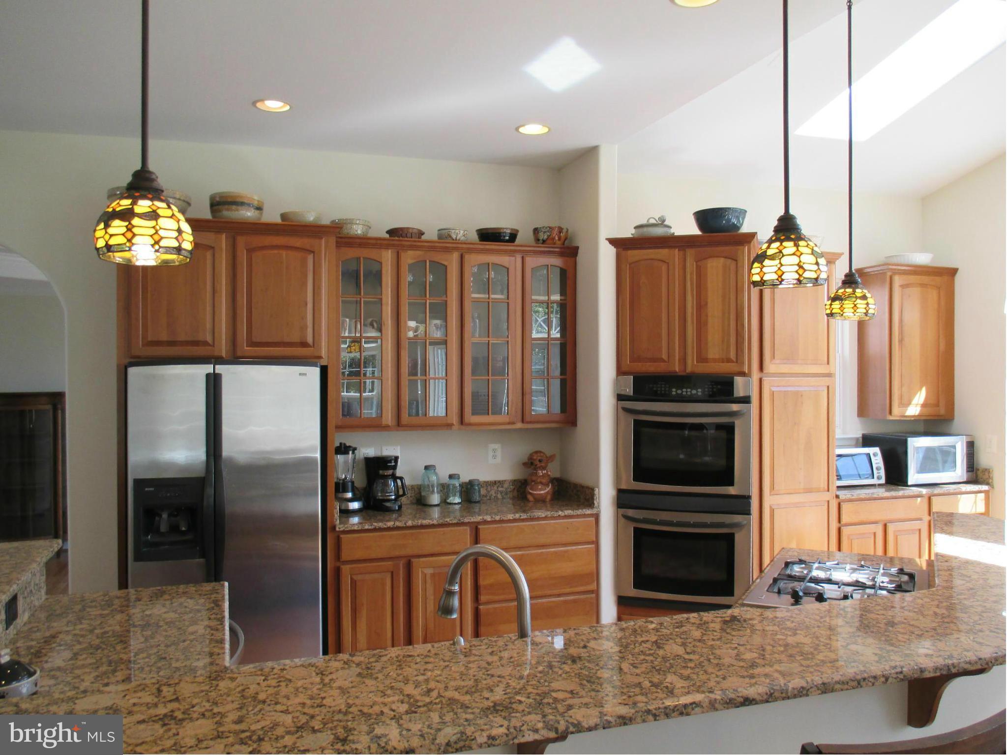 7475 Flint Hill Road Owings, MD 20736 - Photo 8 of 30 a kitchen with stainless steel appliances granite countertop a refrigerator and a sink