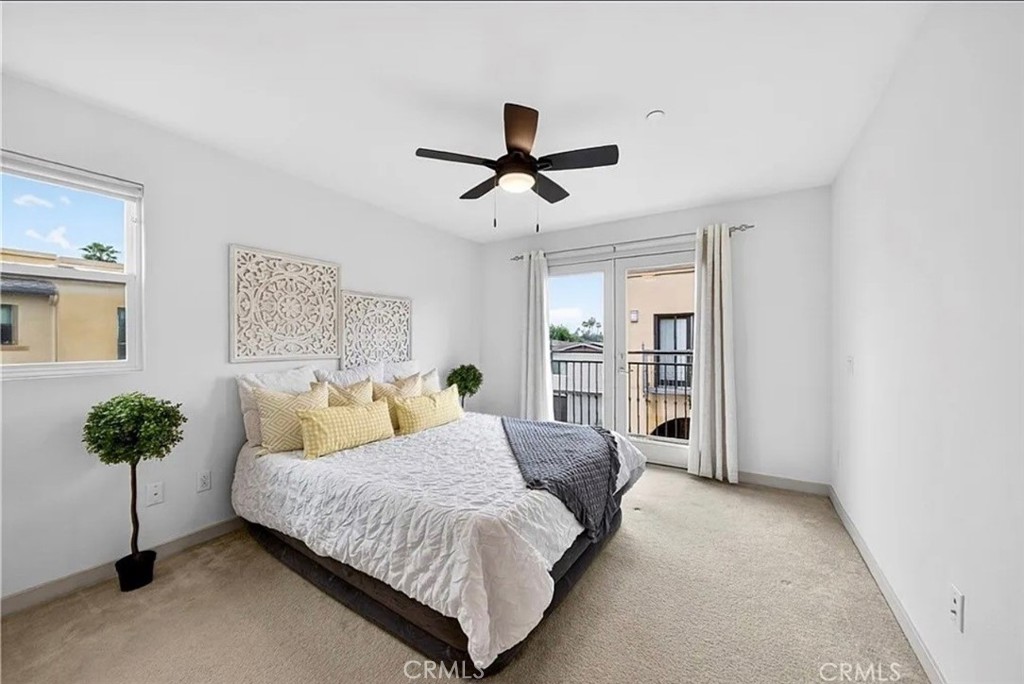 809 Anaheim Boulevard, Unit 106 Anaheim, CA 92805 - Photo 4 of 9 a living room with a bed furniture and a potted plant