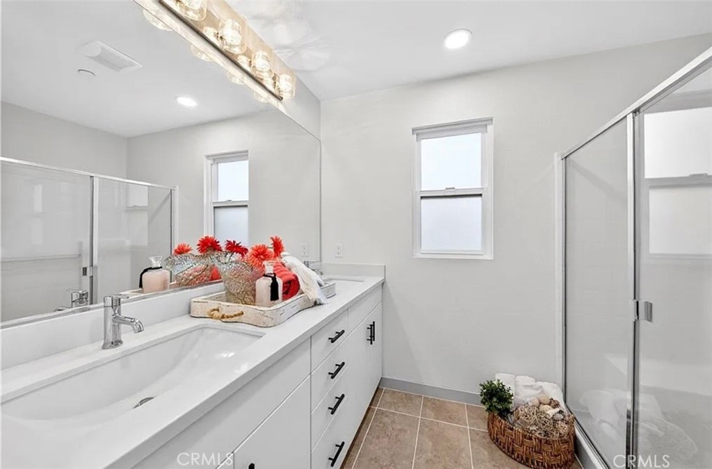809 Anaheim Boulevard, Unit 106 Anaheim, CA 92805 - Photo 6 of 9 a bathroom with a double vanity sink mirror and shower
