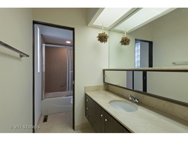 3290 Brook Road Highland Park, IL 60035 - Photo 14 of 19 a bathroom with a granite countertop sink a mirror and a shower