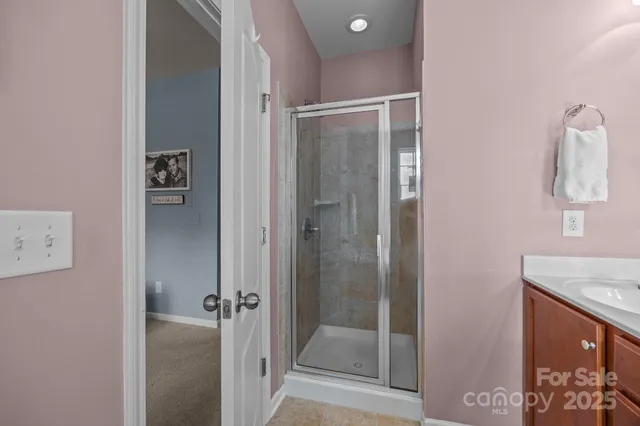 a bathroom with a granite countertop sink and shower