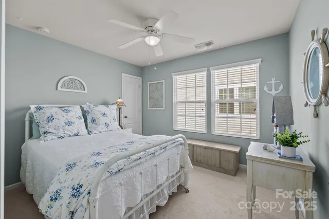 a spacious bedroom with a bed and a chandelier