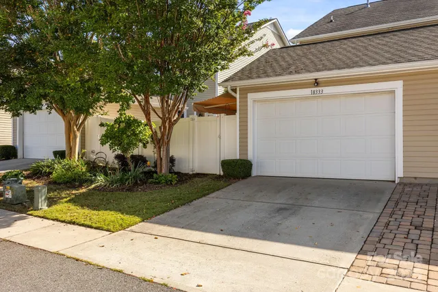 a view of backyard of house and tree