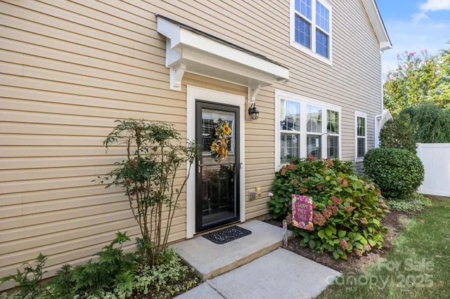 a view of a house with potted plants