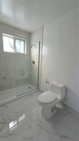 a bathroom with a toilet sink and shower