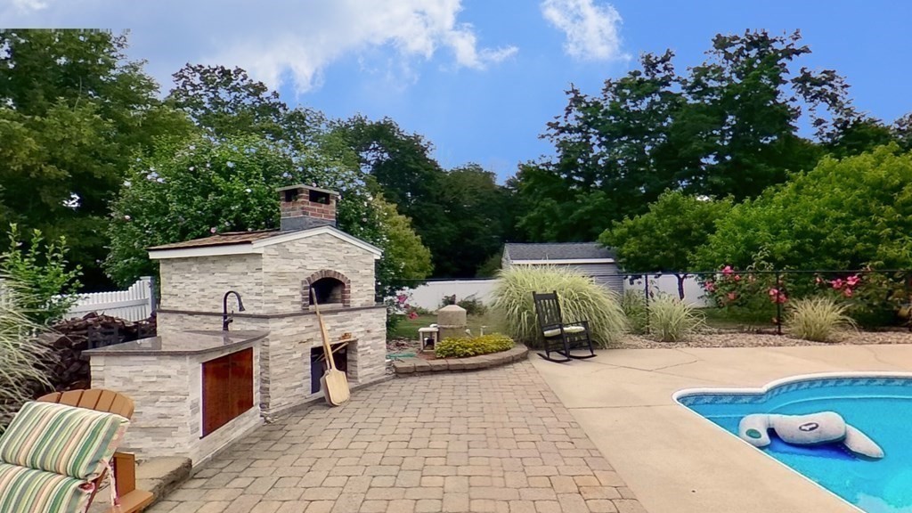 35 Brownfield Drive Bridgewater, MA 02324 - Photo 38 of 42 a view of a patio with couches a table and chairs with wooden fence and plants